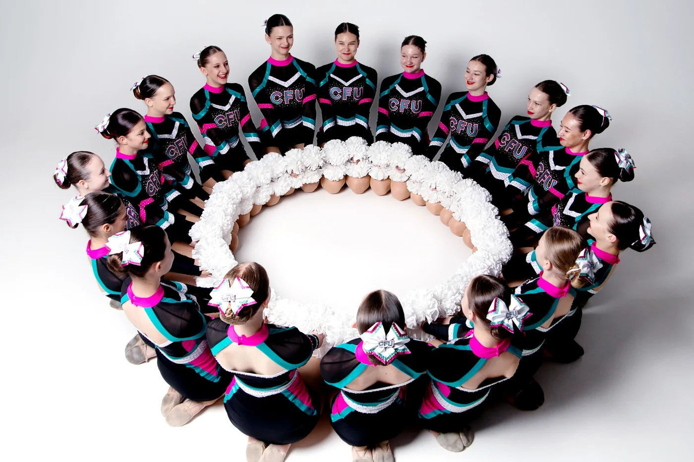 CheerLadies team in a studio circle formation