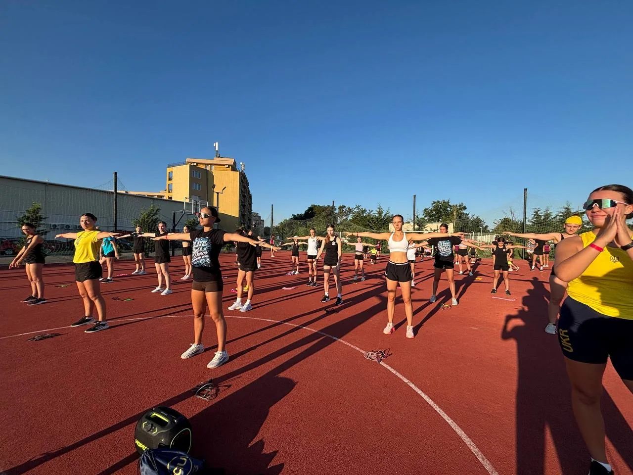 CheerLadies athletes training outdoors during a camp